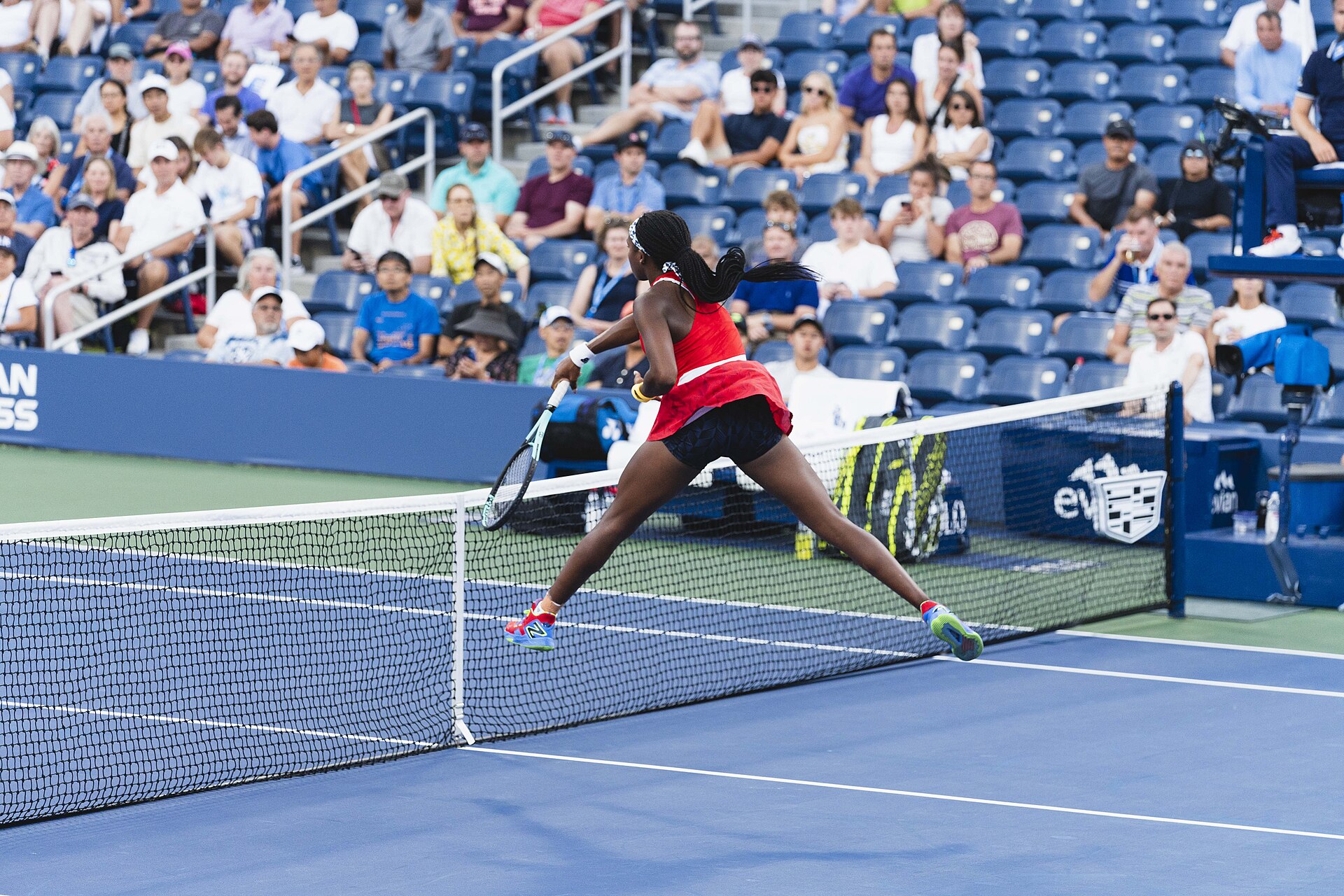 Coco Gauff plays a forehand close to the net during a match